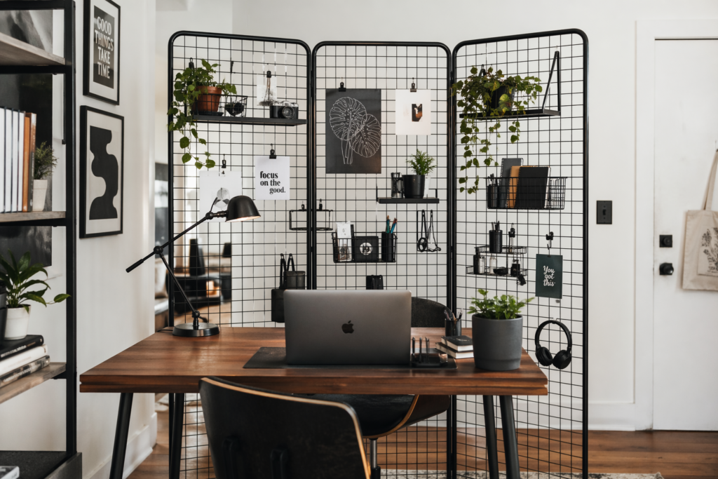 pegboard grid wall divider ideas for small apartments with black wire grid separating home office from living space